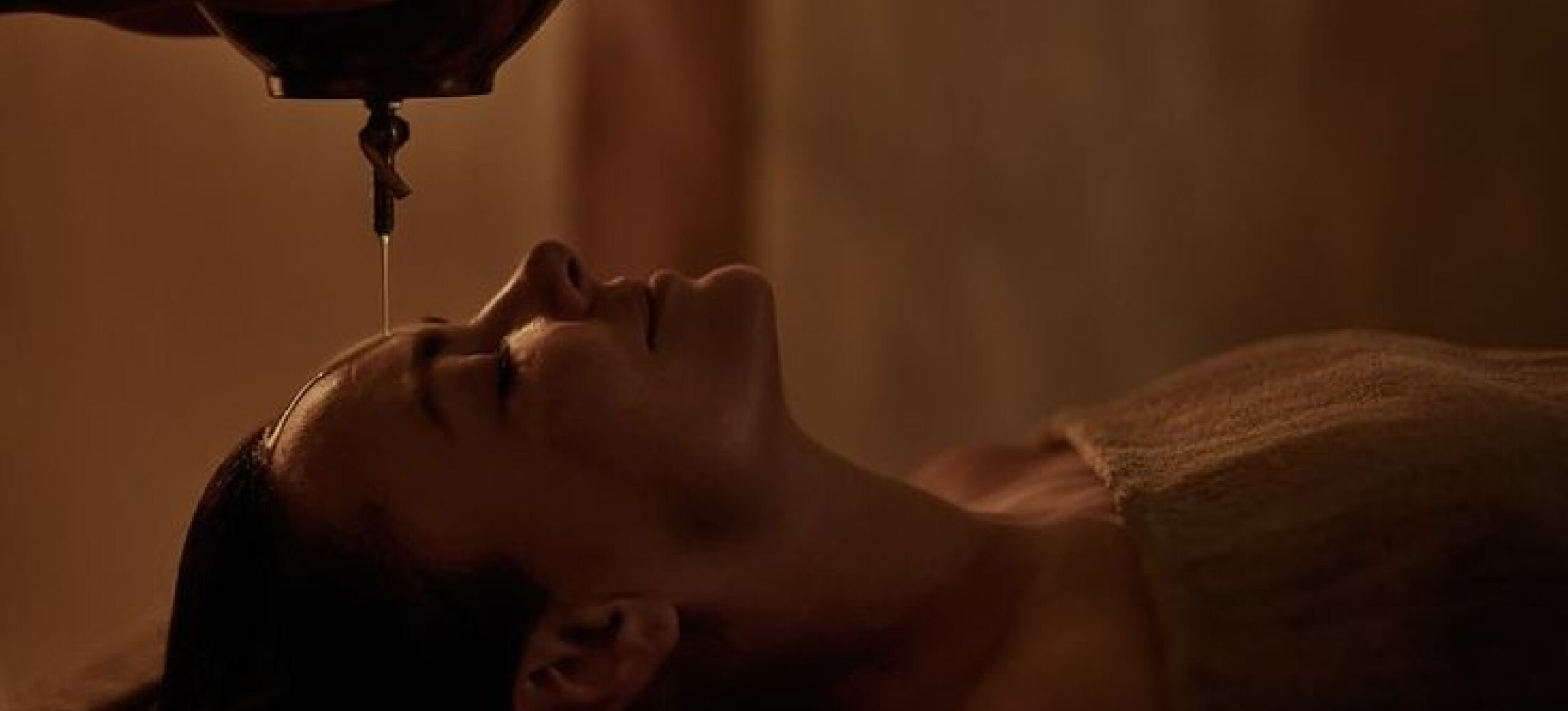 Woman relaxing while receiving a head massage