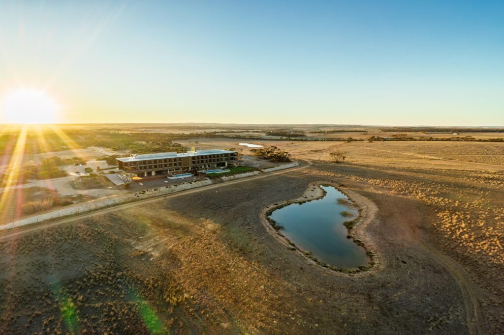 Drone capture of a safari hotel looking out onto a waterhole